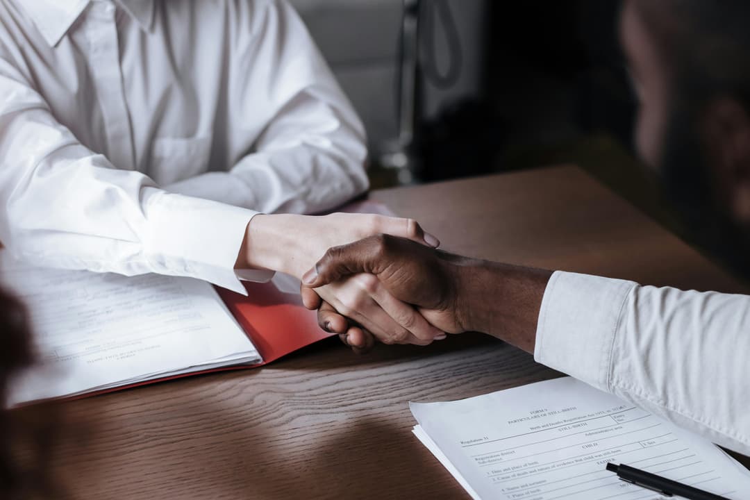 People shaking hands in a business setting